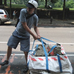 an image from my 48 hours of freedom, this past summer, NYC, James Bell hauling a large bag of rocks and concrete.
