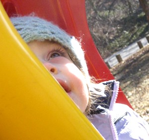 Mimi, on her favorite McDonald's colored swing at the playground.